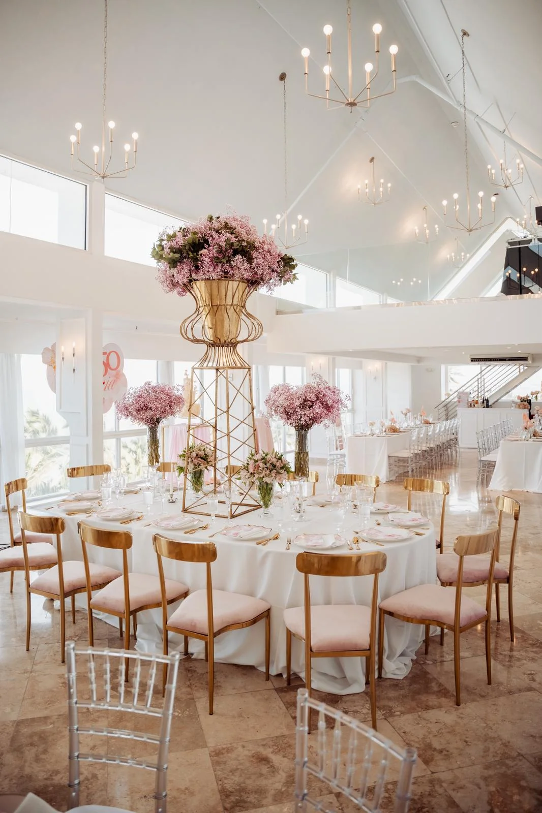 Recepción elegante con centros florales rosados