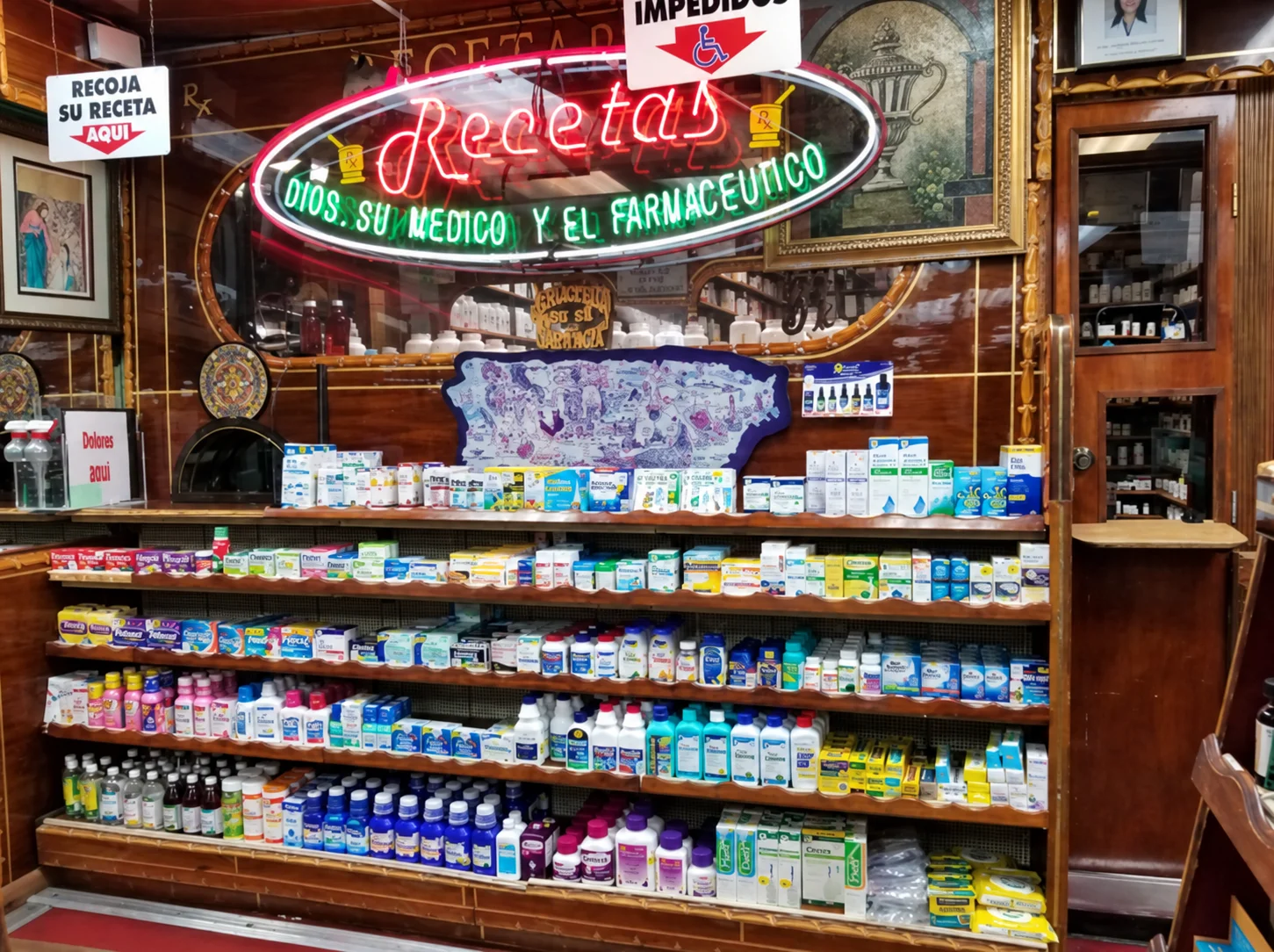 An elderly woman discussing medication options with a pharmacist at a pharmacy counter